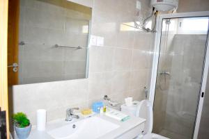 uma casa de banho com um WC, um lavatório e um chuveiro em Lovely - Luxury 3 Bedrooms 500m from the Beach. em Santa Maria