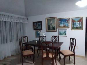 a dining room with a wooden table and chairs at Bed and breaksfast in Punta del Este