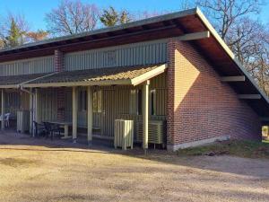 a brick building with an awning on the side of it at 7 person holiday home in Allinge in Allinge