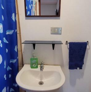 a bathroom with a sink and a blue towel at Lauris Hotel in Lanquín