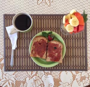 a tray with a plate of toast and a cup of coffee at Lauris Hotel in Lanquín