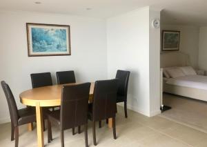 a dining room with a table and chairs and a bed at Arlberg 204 Ski-In Ski-Out Studio Apartment in Mount Buller