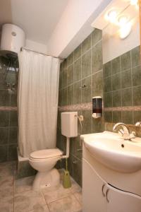 a bathroom with a toilet and a sink at Apartments with a parking space Pirovac, Sibenik - 6246 in Pirovac +23 photos