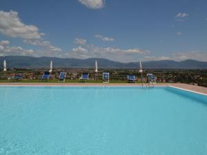 - une piscine avec des chaises et une vue sur la ville dans l'établissement Belvilla by OYO La Casa dei Due Olivi, à Quarrata