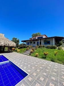 a villa with a swimming pool and a house at Villa Celeste in Doradal