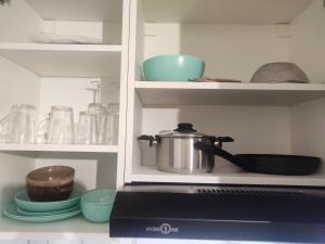 a cupboard with a pot on top of a stove at 36 Dajot Studio Apartment - 25 in Melun