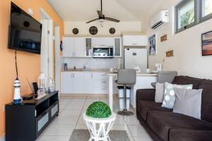 a living room with a couch and a kitchen at Beautiful Ocean Front Villa in Aguada