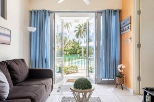 a living room with a couch and a sliding glass door at Beautiful Ocean Front Villa in Aguada