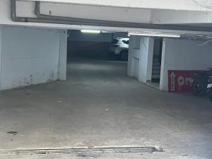 an empty garage with a car parked in it at Hello Hotel in Bùi Tiếng