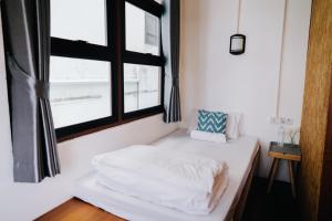 Postel nebo postele na pokoji v ubytování Mystay Hostel Nan