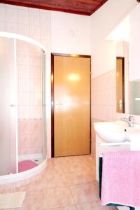 a bathroom with a shower and a sink and a mirror at Apartments by the sea Brgulje, Molat - 6250 in Brgulje