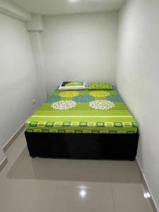 a small room with a bed in a room at Lugar acogedor y muy central en Medellin in Medellín