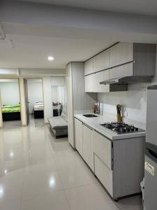 a kitchen with a stove top oven in a room at Lugar acogedor y muy central en Medellin in Medellín