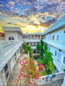 a view of a building with flowers in a courtyard at Sai Baba Haveli in Pushkar
