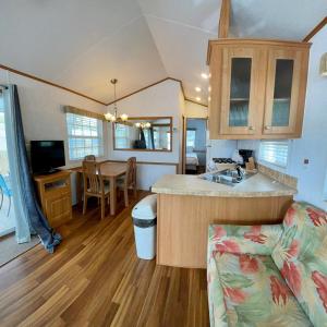 a kitchen and living room with a sink and a table at Ocean Grove RV Resort St Augustine in Saint Augustine