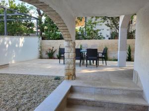 an outdoor patio with a table and chairs at Triple Room Selce 2379a in Selce