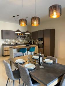 a kitchen and dining room with a table and chairs at Sea-view Apartment in Marsalforn in Marsalforn