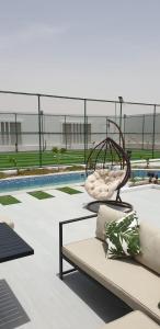a swing in the middle of a pool at VENESIA chalet in Al Kāmil