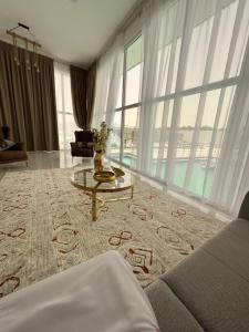 a living room with a couch and a table at VENESIA chalet in Al Kāmil