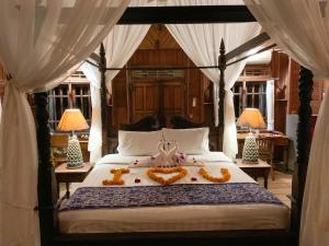a bedroom with a bed with two teddy bears on it at Secret Moon Beach House in Jasri +62 photos