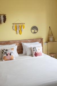 a bedroom with a white bed with stuffed animals on it at THE SPARE ROOM BALI in Canggu