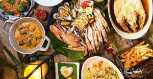 a table topped with plates of food and bowls of food at Siya Private Pool Villa Ao Nang in Ao Nang Beach