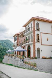 a large brick building with a building with a patio at Hotel Chateau Iveri in Varjanisi