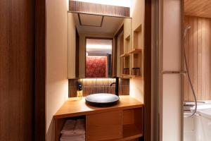 a bathroom with a sink and a mirror at Rinn Gion Kenninji in Kyoto