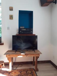 a wooden table with a television on top of it at Le Studio du Crot Noir in Cussy-en-Morvan