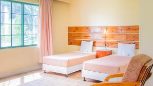 Postel nebo postele na pokoji v ubytování Garden Villa Hotel