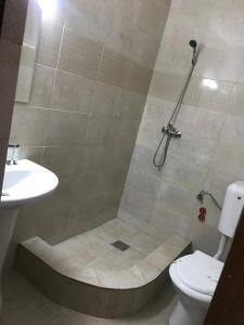 a bathroom with a shower with a toilet and a sink at CASA DENIZ in 2 Mai