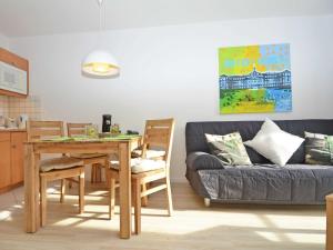 a living room with a table and a couch at Wohnpark Stadt Hamburg - Apt. 01 in Binz