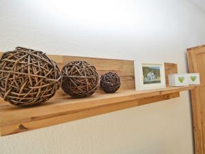 three baskets sitting on a wooden shelf with pictures at Wohnpark Stadt Hamburg - Apt. 01 in Binz