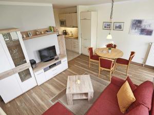 a living room with a couch and a table at Wohnpark Stadt Hamburg - Apt. 04 in Binz