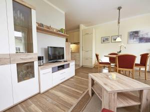 a living room with a table and a tv at Wohnpark Stadt Hamburg - Apt. 04 in Binz