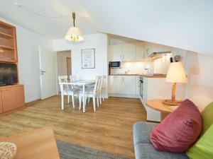 a living room with a table and a kitchen at Wohnpark Stadt Hamburg - Apt. 05 in Binz