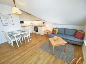 a living room with a couch and a table at Wohnpark Stadt Hamburg - Apt. 05 in Binz