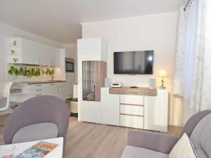 a living room with a tv on a wall at Wohnpark Stadt Hamburg - Apt. 09 in Binz