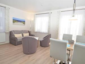 a living room with a couch and a table at Wohnpark Stadt Hamburg - Apt. 09 in Binz