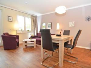 a living room with a wooden table and chairs at Wohnpark Stadt Hamburg - Apt. 10 in Binz