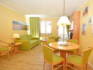 ein Wohnzimmer mit Tisch und Stühlen in der Unterkunft Wohnpark Stadt Hamburg - Apt. 15 in Binz