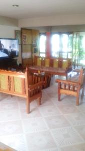 a living room with tables and chairs and a television at Hotel Mixti in Cuetzalán del Progreso