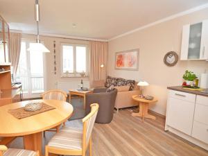 a kitchen and living room with a table and a dining room at Wohnpark Stadt Hamburg - Apt. 22 in Binz