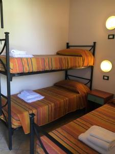 two bunk beds in a room with towels on them at Michelangelo Holiday & Family Resort in Lido di Spina