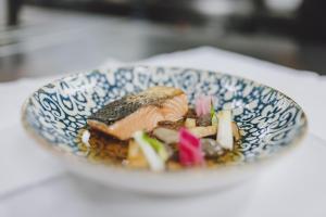 a blue and white bowl of food on a table at Hotel DIE SONNE in Saalbach Hinterglemm