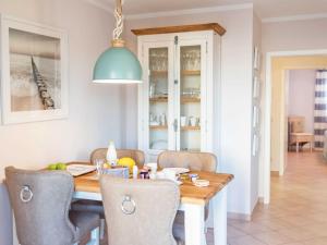 a kitchen and dining room with a table and chairs at Wohnpark Stadt Hamburg - Apt. 30 in Binz
