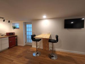 cocina con mesa de madera y 2 taburetes negros en Private Studio Close to Downtown Rhinebeck en Rhinebeck