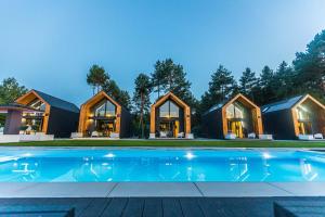 a house with a swimming pool in front of it at Natura Park Radawa in Radawa
