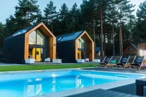 a house with a pool in front of it at Natura Park Radawa in Radawa