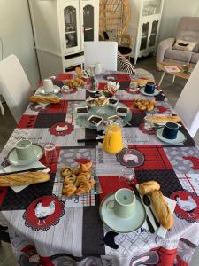 a table with a table cloth with food on it at LA MAISON DES HIPPOCAMPES in La Teste-de-Buch +14 photos